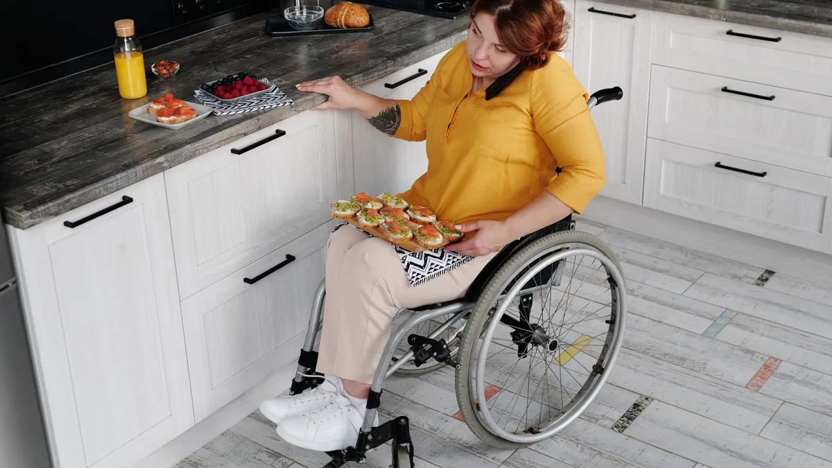 Accessible home kitchen with a phone showing a bank deposit notification