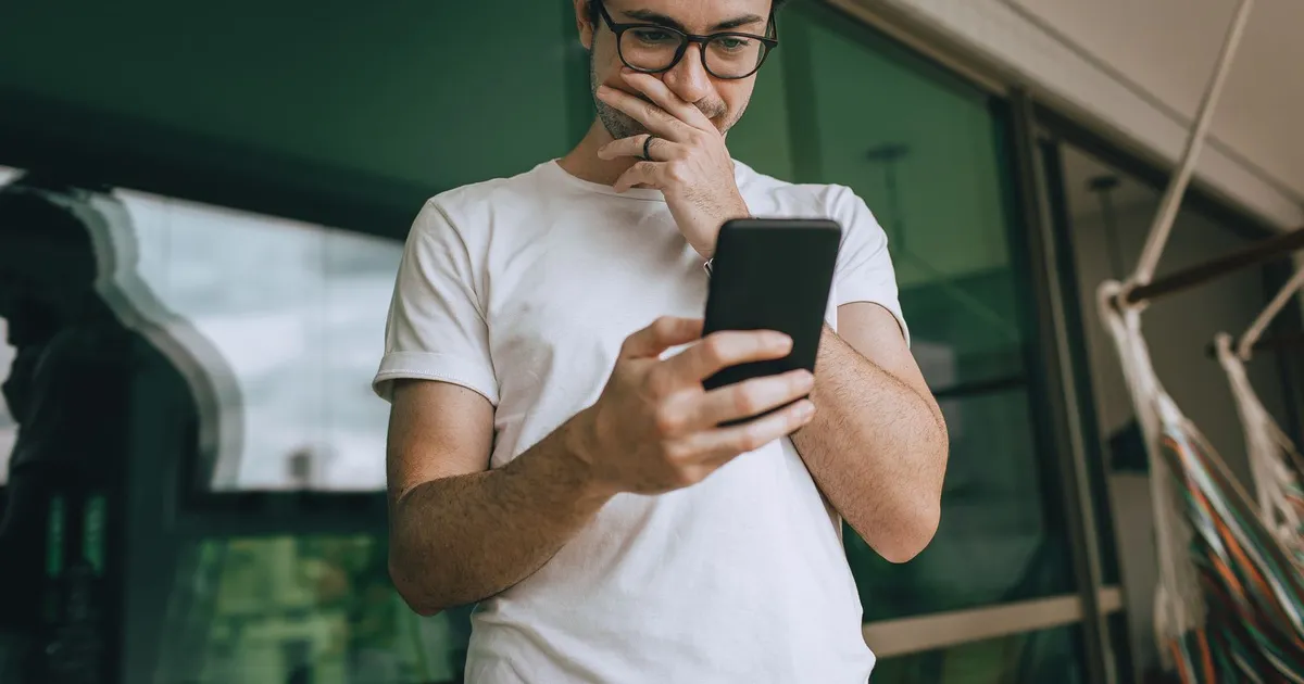 Person thinking through a phone application because they need a loan no credit check lenders will approve